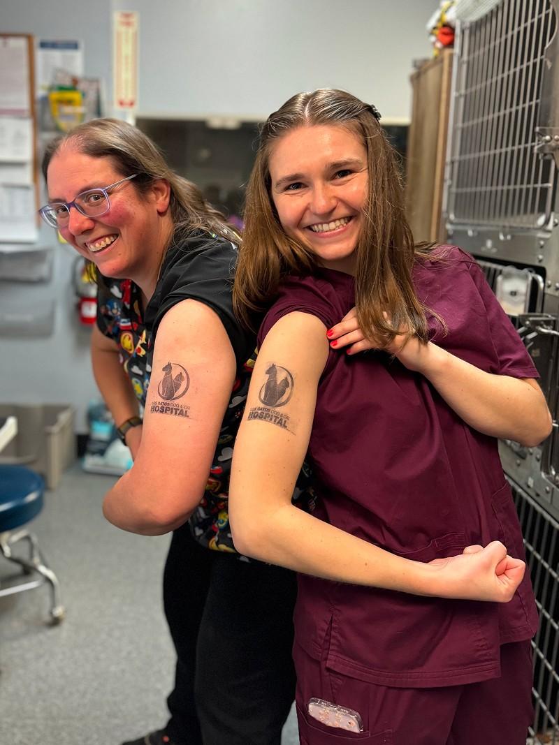 two vets having fun with los gatos tattoo on hand